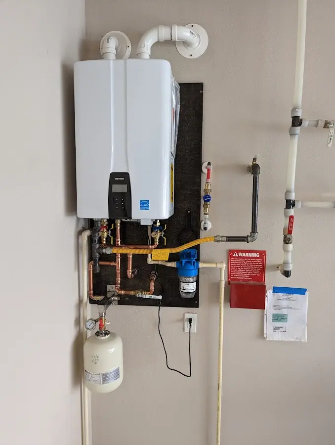 Professional plumber installing copper piping in a Groves home